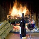 a glass of wine in front of a fireplace